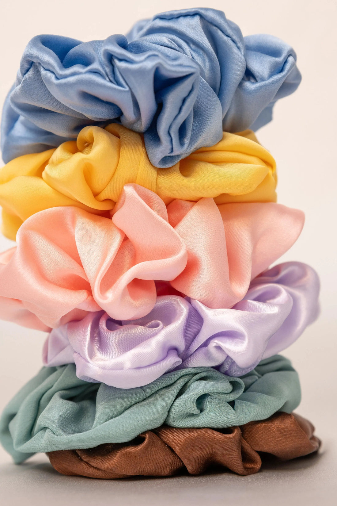Colourful Lunelle mulberry silk scrunchies arranged on a clean surface - how to wash silk scrunchies and hair ties safely without ruining them