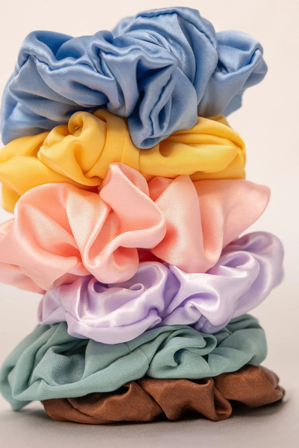 Colourful Lunelle mulberry silk scrunchies arranged on a clean surface - how to wash silk scrunchies and hair ties safely without ruining them